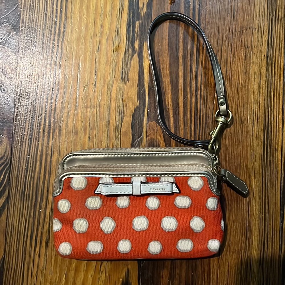 Coach wristlet, orange and white polkadot with striped liner and gold strap
